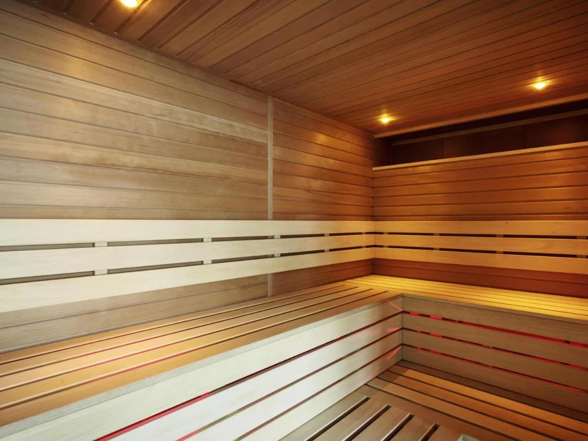 a large wooden sauna with wood paneling at Novotel Cambridge North in Cambridge